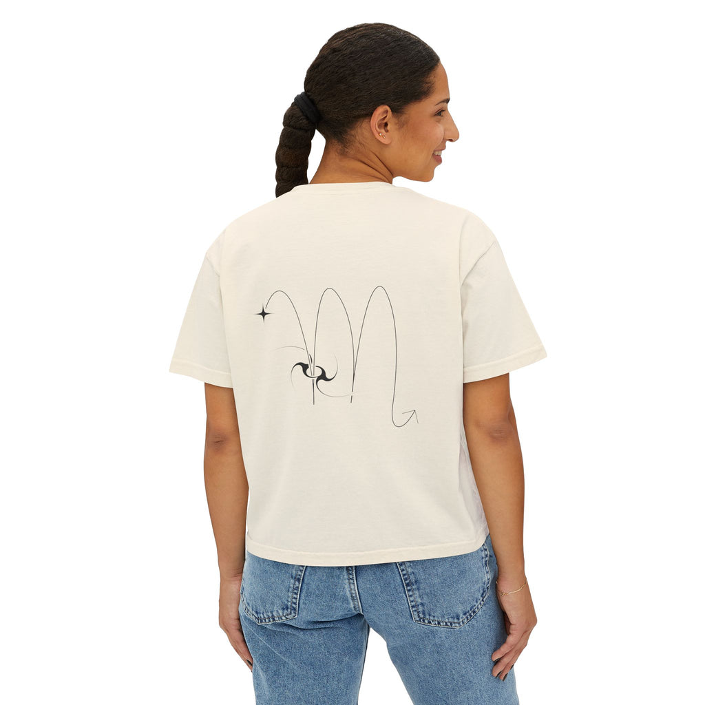 Person wearing a Beige t-shirt with a minimalist Scorpio zodiac design in orbital line-art in the back