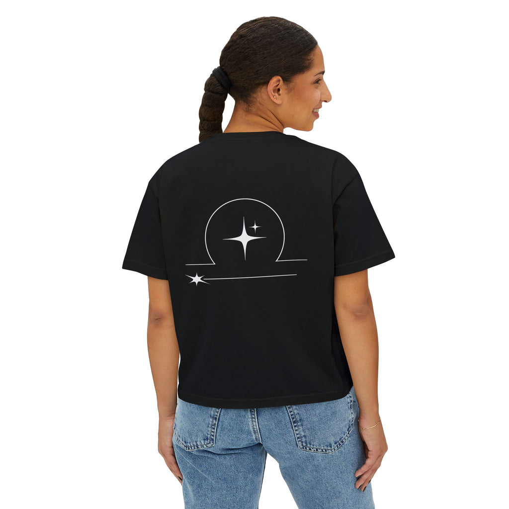 Person wearing a Black t-shirt with a minimalist Libra zodiac design in orbital line-art in the back