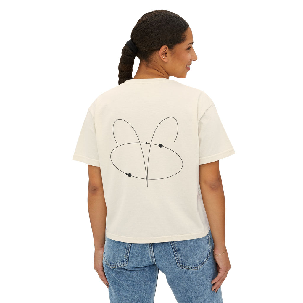 Person wearing a Beige t-shirt with a minimalist Aries zodiac design in orbital line-art in the back