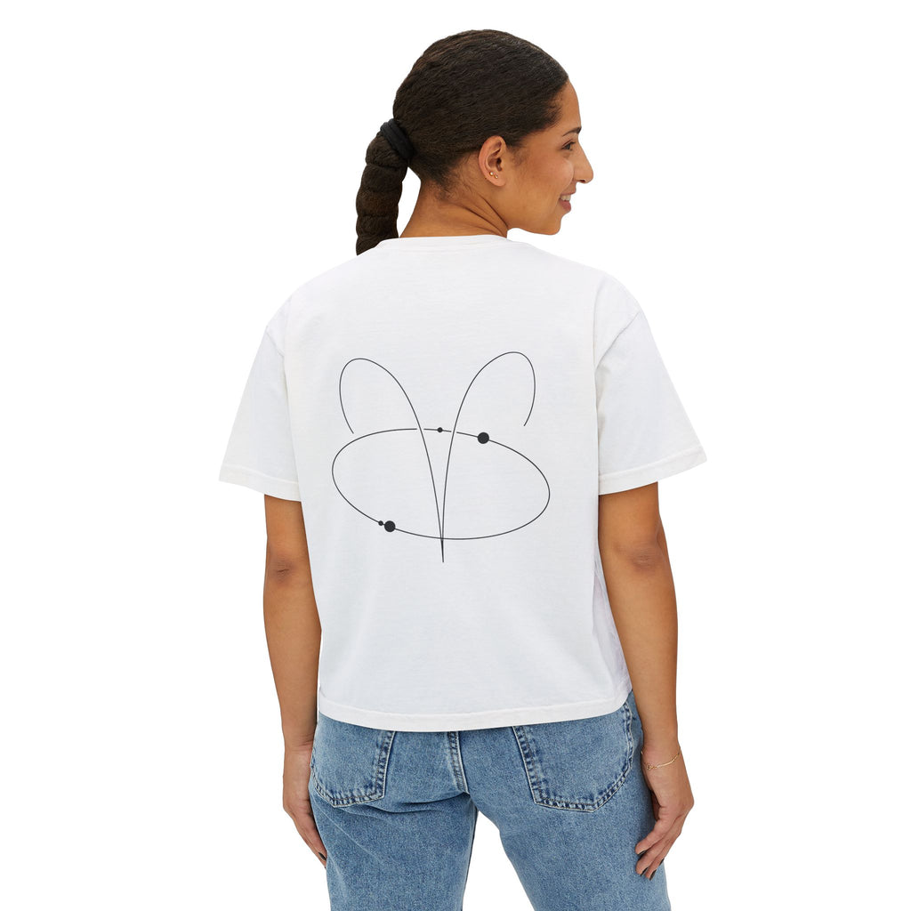 Person wearing a white t-shirt with a minimalist Aries zodiac design in orbital line-art in the back