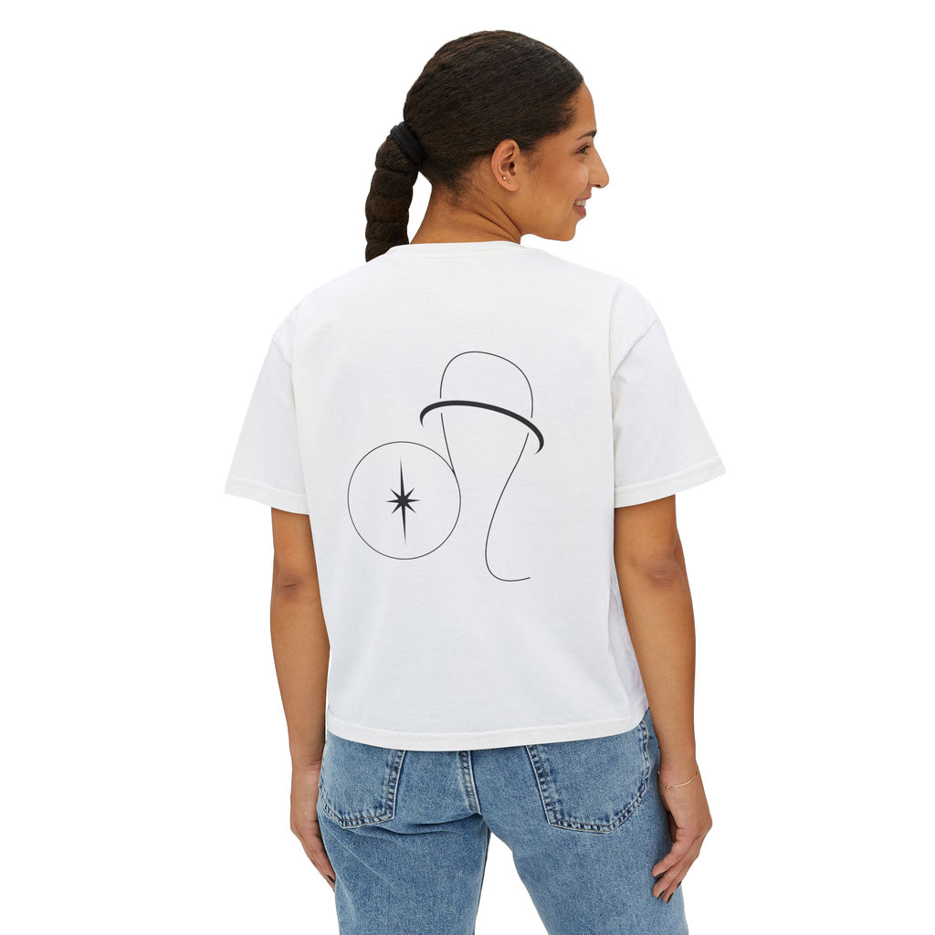 Person wearing a white t-shirt with a minimalist Leo zodiac design in orbital line-art in the back